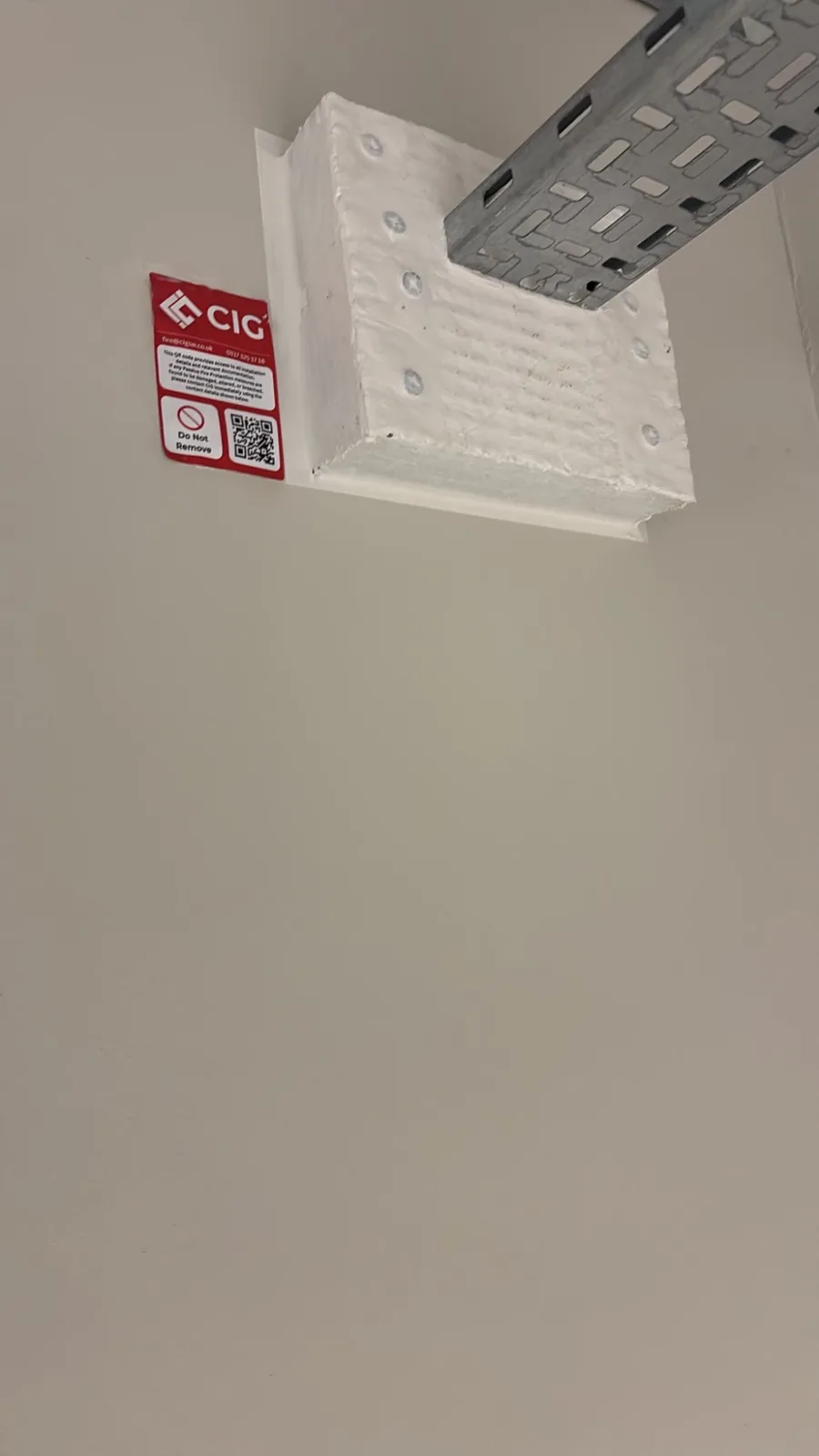 Coated ablative batt seal around a cable tray penetration with a CIG label