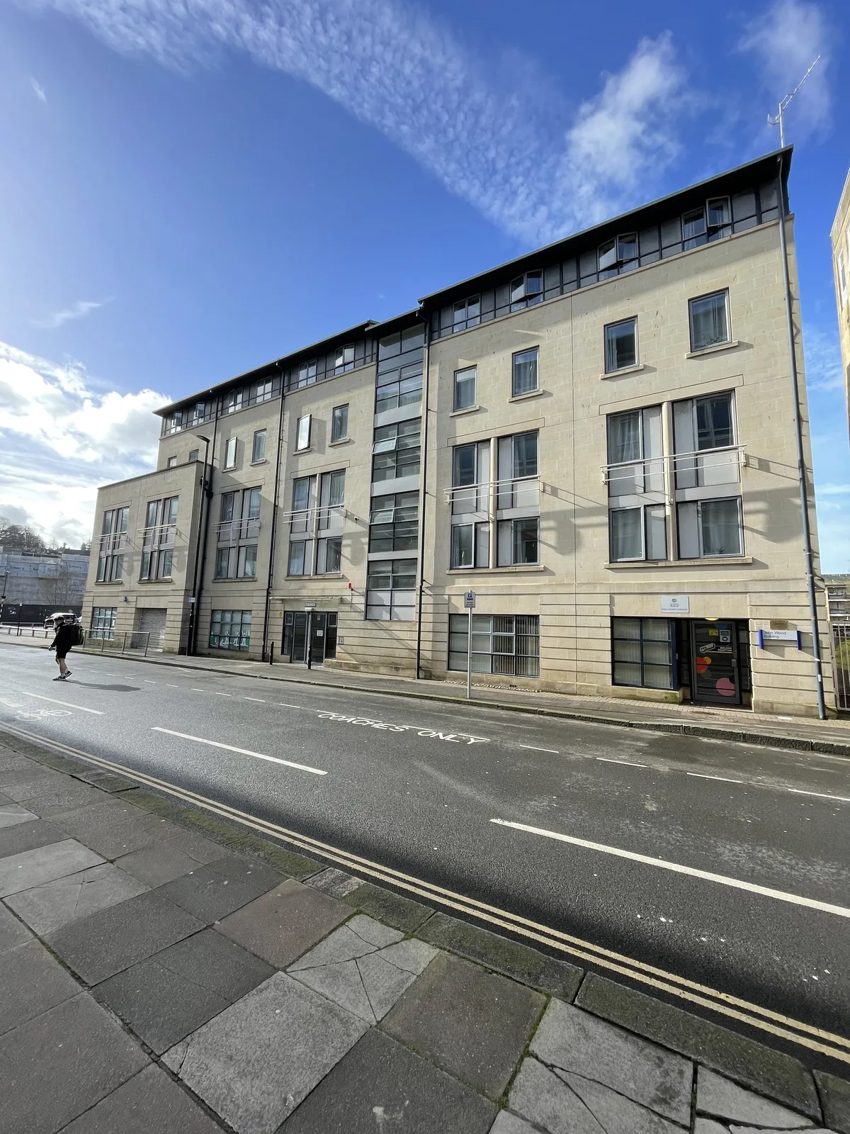 Bath-stone student accommodation block seen from the street on a sunny day