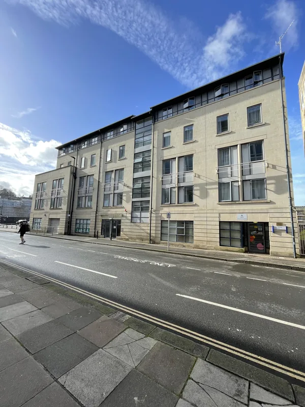 Bath-stone student accommodation block seen from the street on a sunny day