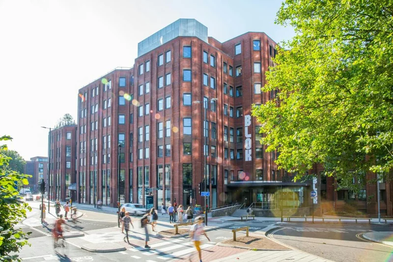 One Castle Park, a red-brick eight-storey office building beside Castle Park in Bristol, seen from the street corner